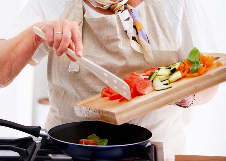 Frau kocht Gemüse © Yuri Arcurs - Fotolia.com Frau kocht Gemüse